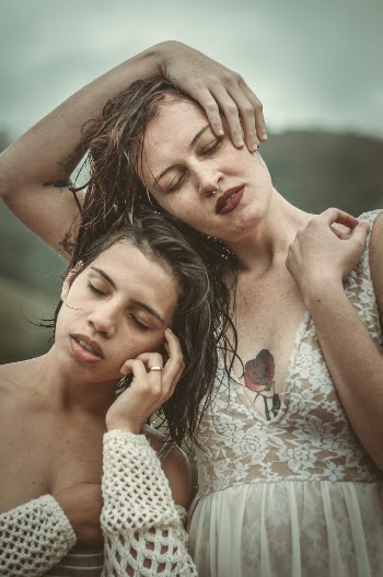 Selective Focus Photography of Women Standing Side by Side With Eyes Closed