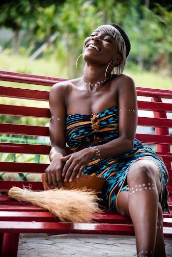 Selective Focus Photography Woman Sitting on Red Bench laughing