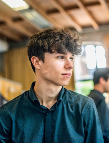 Selective Focus Portrait Photo of Man in Black Dress Shirt Looking to His Left
