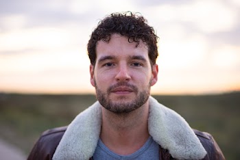 Selective Focus Portrait Photo of Man in Brown Leather Jacket Posing