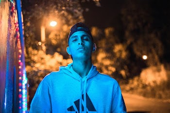 Selective Focus Portrait Photo of Man in Hat and Hoodie Posing