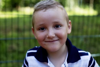 Selective Focus Portrait Photo of Smiling Boy