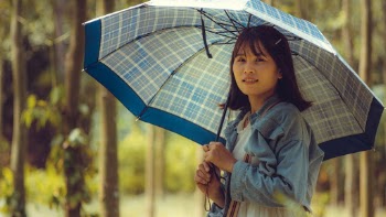 Selective Focus Portrait Photo of Woman Holding an Umbrella