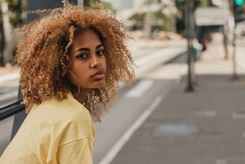 Selective Focus Portrait Photo of Woman Posing by Sidewalk