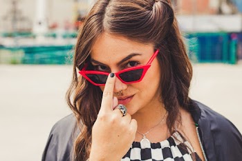 Selective Focus Portrait Photo of Woman Posing in Black Sunglasses With Red Frames