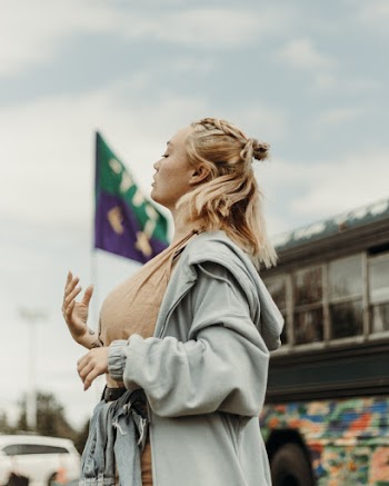 Selective Focus Side View Photo of Woman Gray Zip-up Jacket Standing With Her Eyes Closed