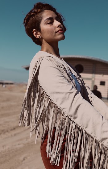 Selective Focus Side View Photo of Woman Wearing Beige Long-sleeved Shirt With Fringe Posing With Her Eyes Closed