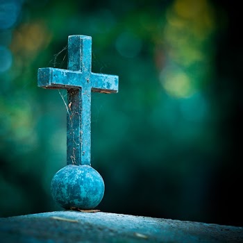 Selective Photo of Teal Cross Decor
