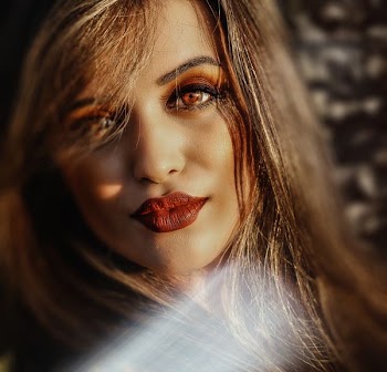selective photo of woman wearing red matte lipstick
