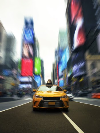 Selective Photo of Yellow Cab on Road