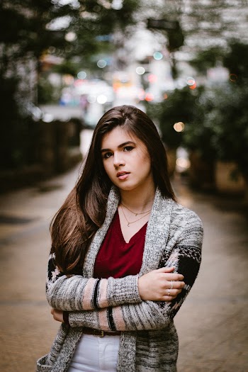 Selective photography of a woman wearing grey sweater with her arms crossed