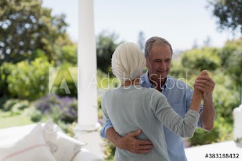 Senior couple dancing on patio