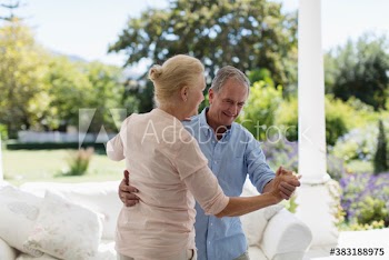 Senior couple dancing on patio