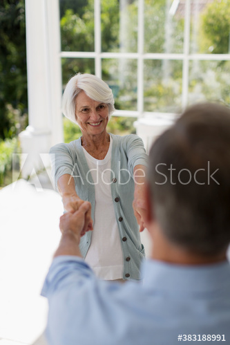 Senior couple dancing on patio