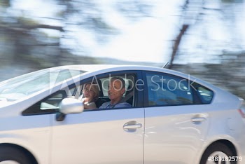 Senior couple driving car
