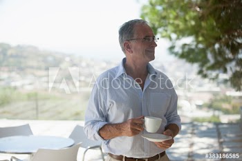 Senior man drinking coffee on patio