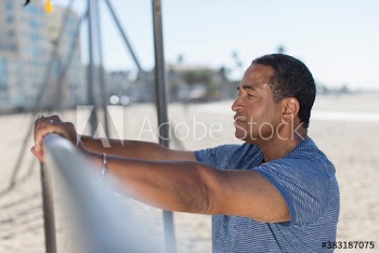 Senior man exercising on sunny beach