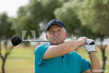 Senior man golfing