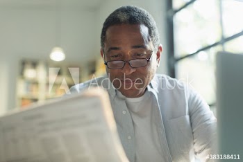 Senior man reading newspaper