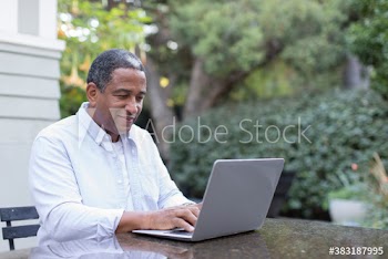 Senior man using laptop on patio