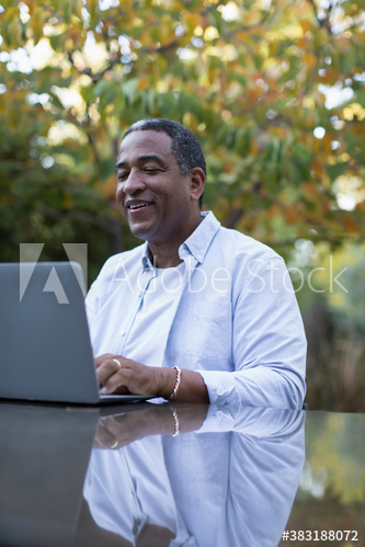 Senior man using laptop on patio