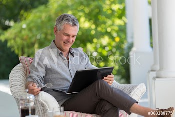 Senior man using laptop on patio