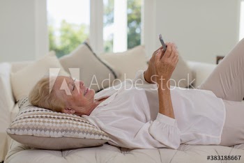 Senior woman relaxing with smart phone