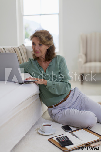 Senior woman using laptop in living room