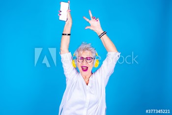 Senior woman with eyes closed dancing while listening to music