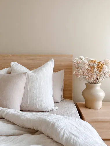 Serene Bed Corner with Crinkled Linen and Dried Flowers Serene Bed Corner with Crinkled Linen and Dried Flowers