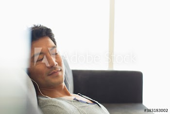 Serene man listening to music with headphones