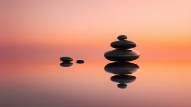 Serene Sunrise with Stacked Zen Stones