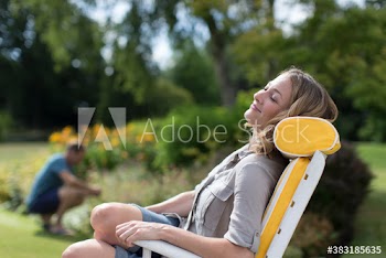 Serene woman relaxing in lawn chair