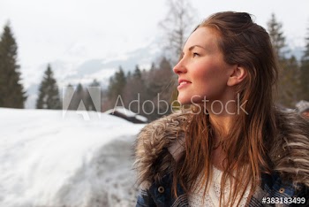 Serene young woman in snowy field