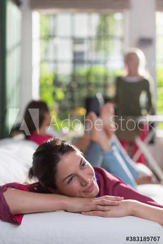 Serene young woman relaxing on sofa
