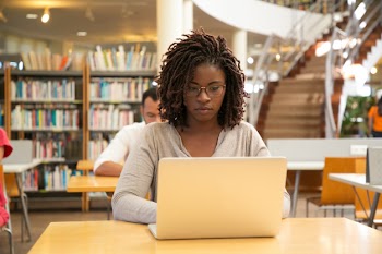 Serious african american student working on research Free Photo