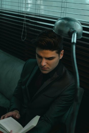 Serious man in formal coat reading book · Free Stock Photo