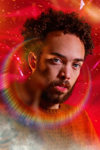 Serious man with rainbow halo around head · Free Stock Photo
