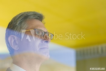 Serious thoughtful businessman looking away