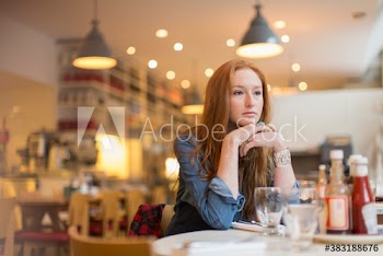 Serious young woman in cafe