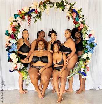 Seven black women within a flower swing