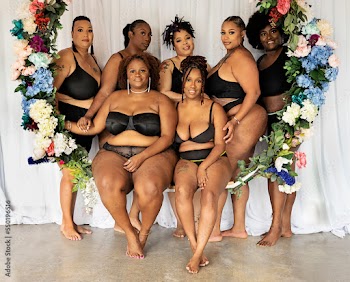 Seven black women within a flower swing