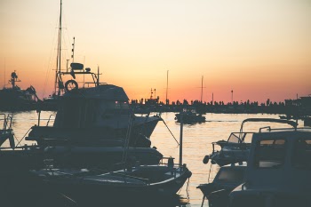 Several Boats on Calm Water during Golden Hour