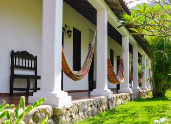 Several Orange Hammocks Hanged on White Concrete Posts
