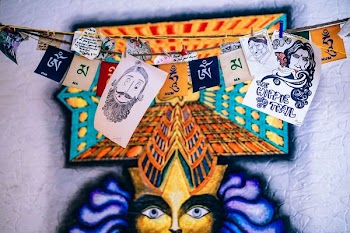 several paintings hang on wire