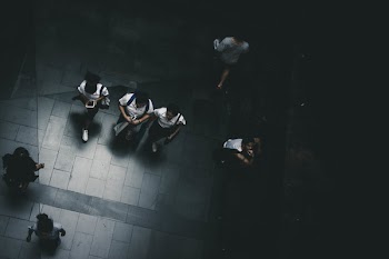 Several People Waking on Pathway at Night
