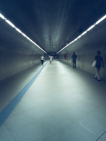 Several People Walking On Hallway