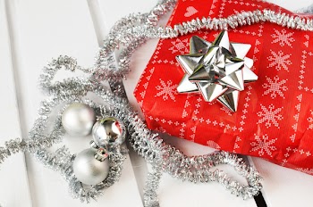 Several Silver Bauble Balls Beside Red Wrapper