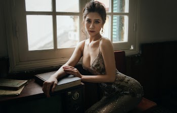 Sexy girl sitting near the window