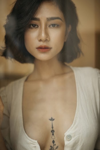 Sexy girl with tattoo on the chest